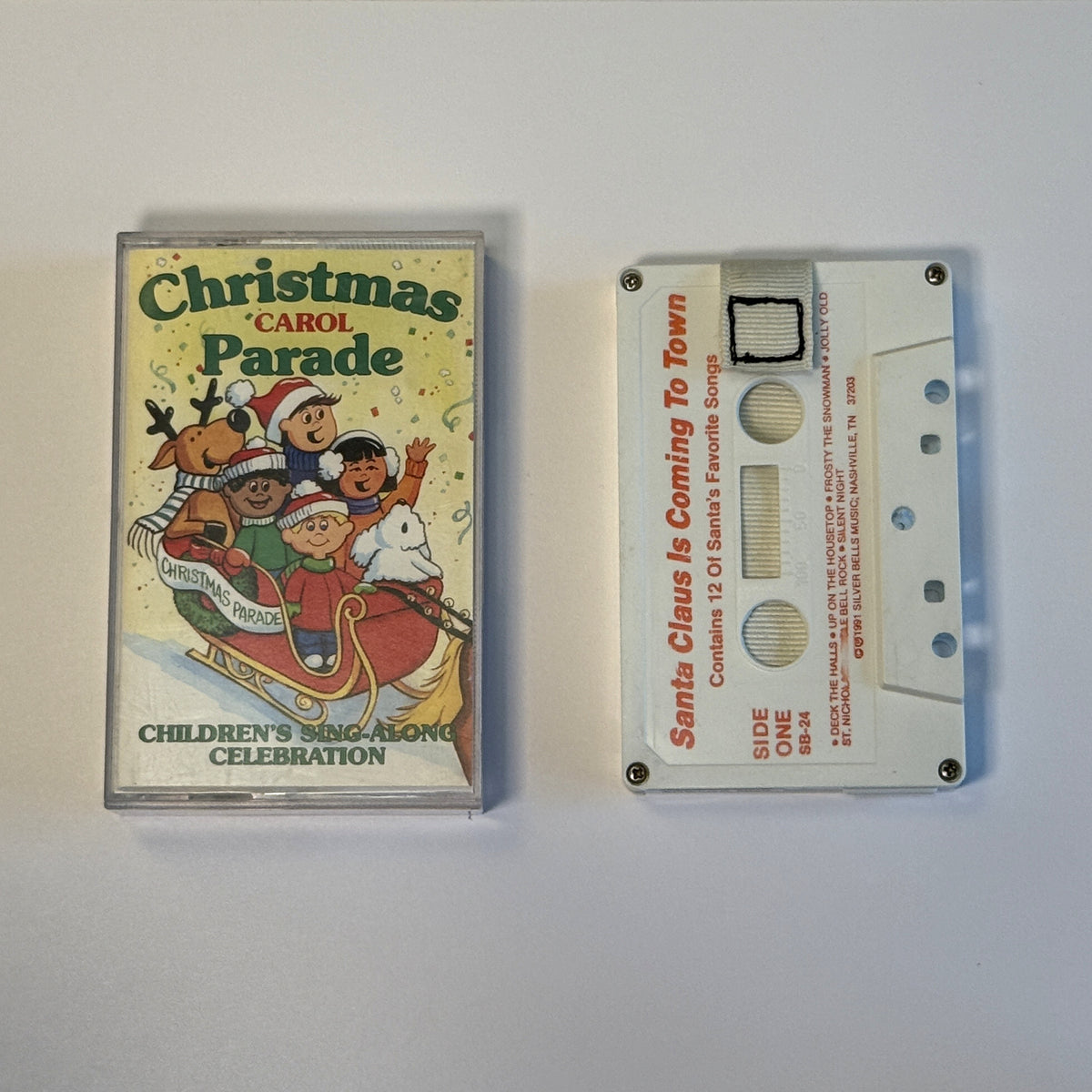 Alternate view of the Santa Claus Is Coming to Town cassette wallet and Christmas Carol Parade case