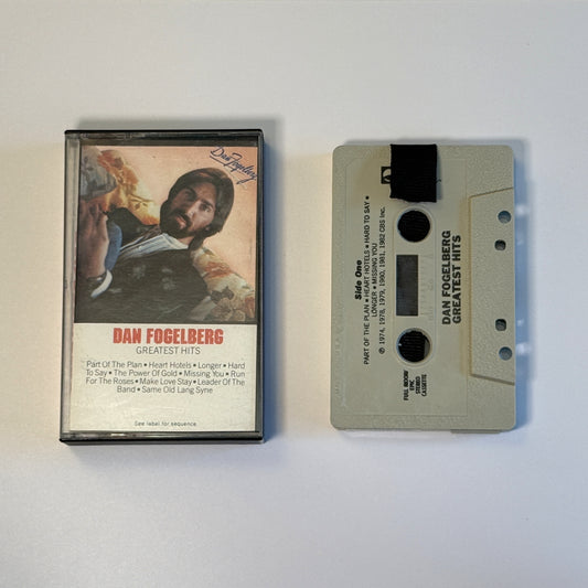 Dan Fogelberg Greatest Hits gray cassette wallet with a black pull tab beside the original case