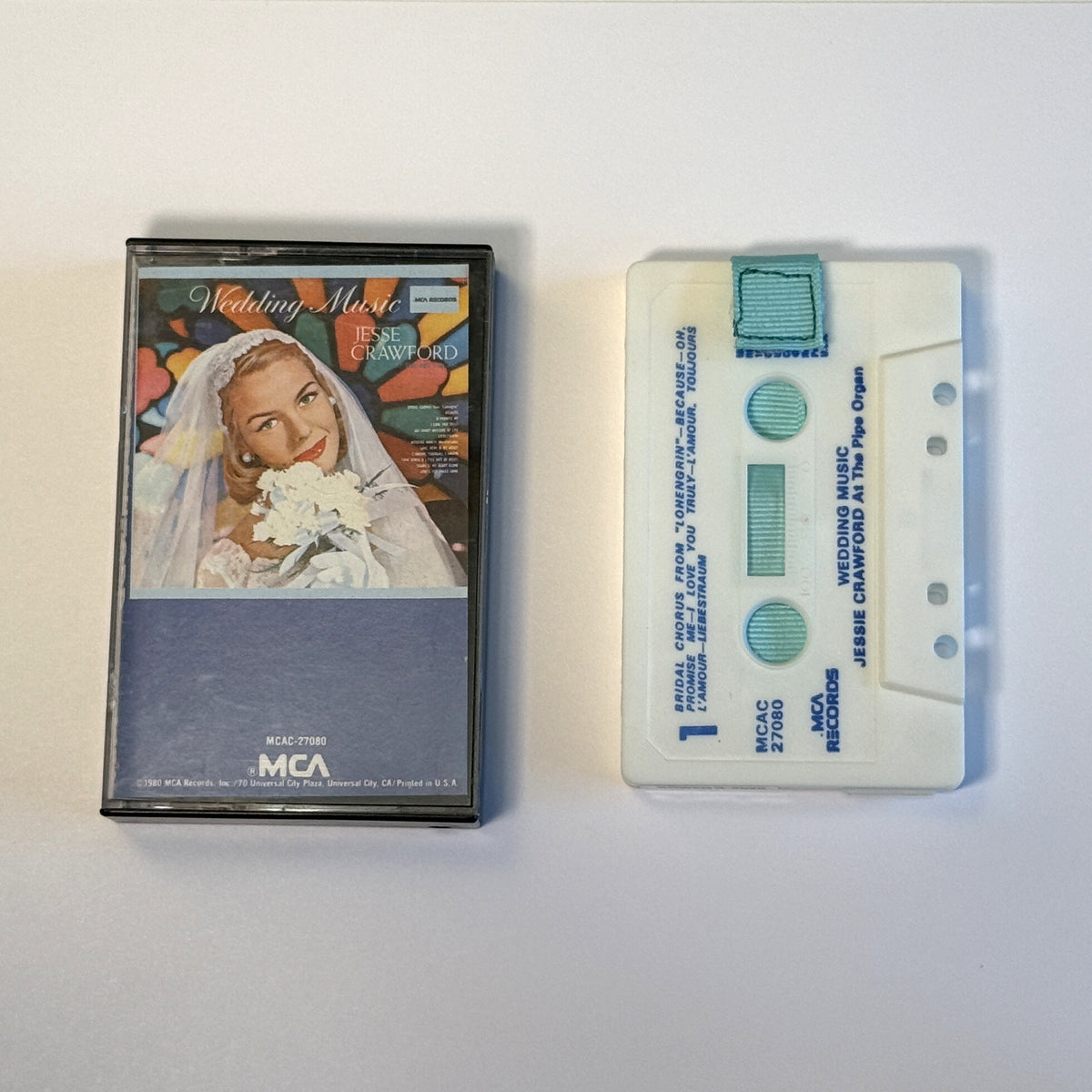 Jesse Crawford Wedding Music white cassette wallet with a light blue pull tab beside its original case