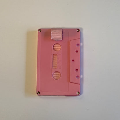 Solid pink cassette wallet with a light pink pull strap