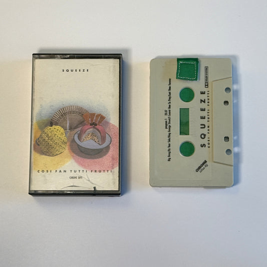 Squeeze Cosi Fan Tutti Frutti white cassette wallet with a green pull tab beside the original case