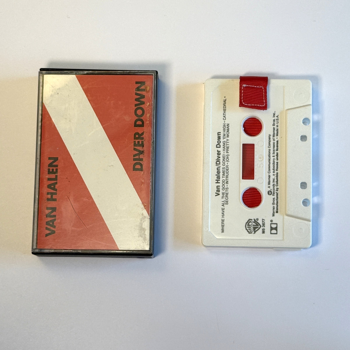 Van Halen Diver Down gray cassette wallet with a red pull tab beside the red and white original case