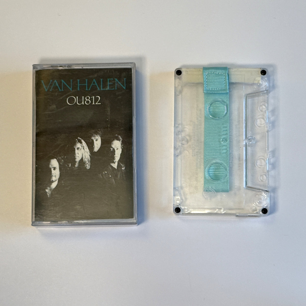 Van Halen OU812 clear cassette wallet with an aqua pull tab beside the original case